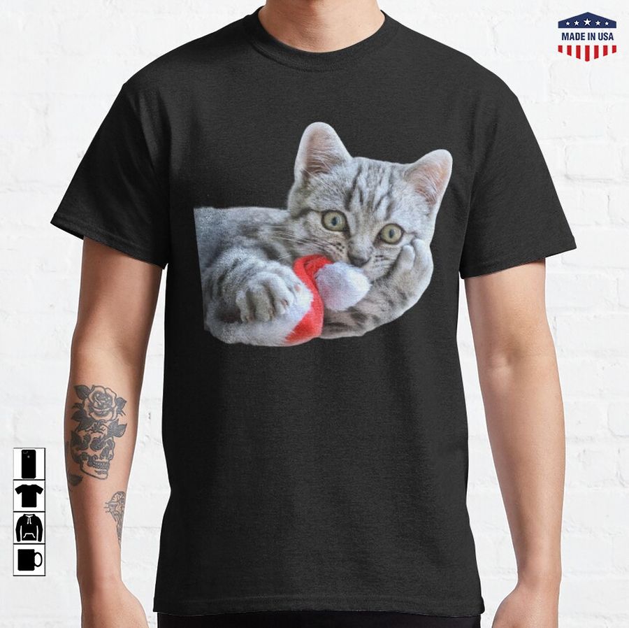 Adorable Christmas cat nibbles on red Santa Claus hat Classic T-Shirt